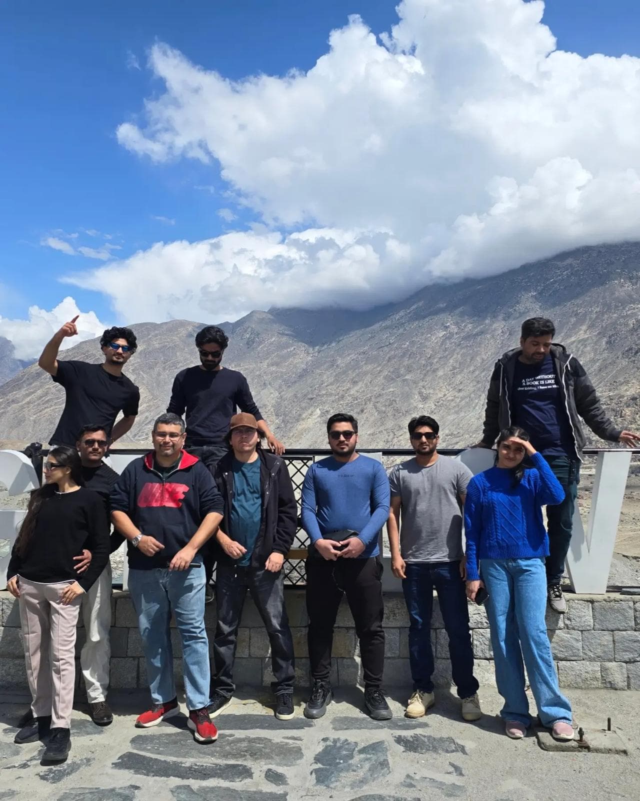 Karawaan group with mountains behind them in Skardu